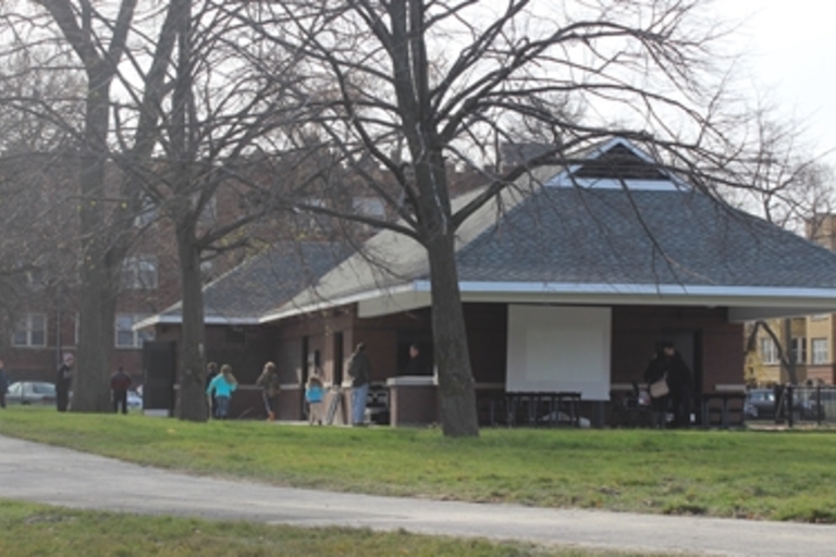Park shelter with people on an autumn day.