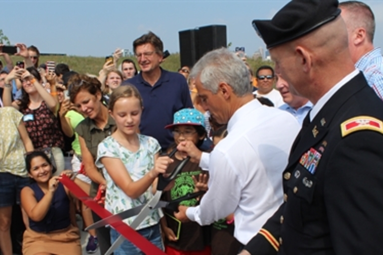 Ribbon-cutting ceremony with crowd and officials.
