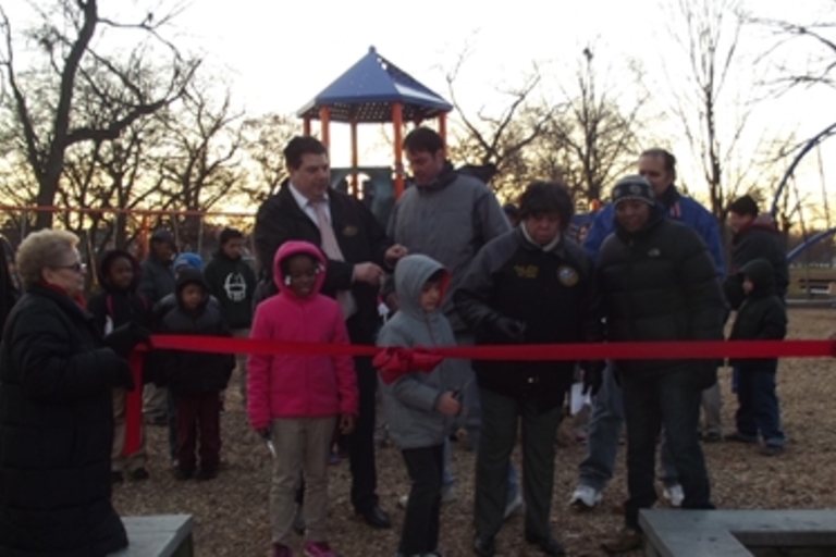 Ribbon-cutting ceremony at a playground.