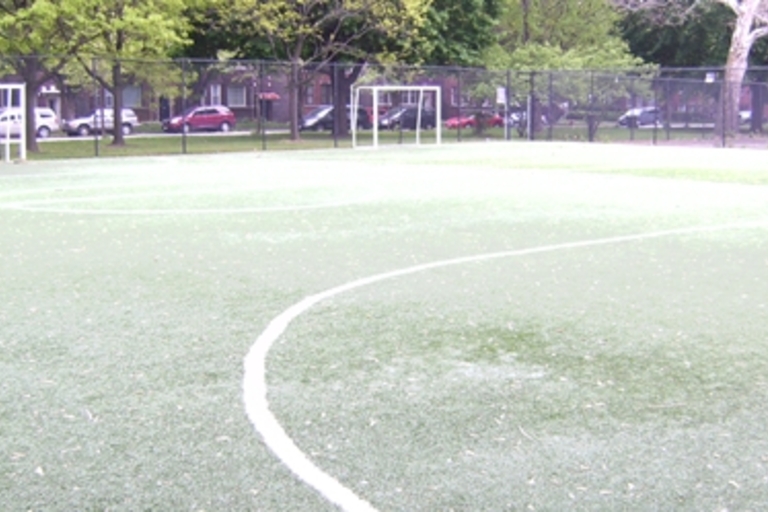 Empty turf soccer field with goals.