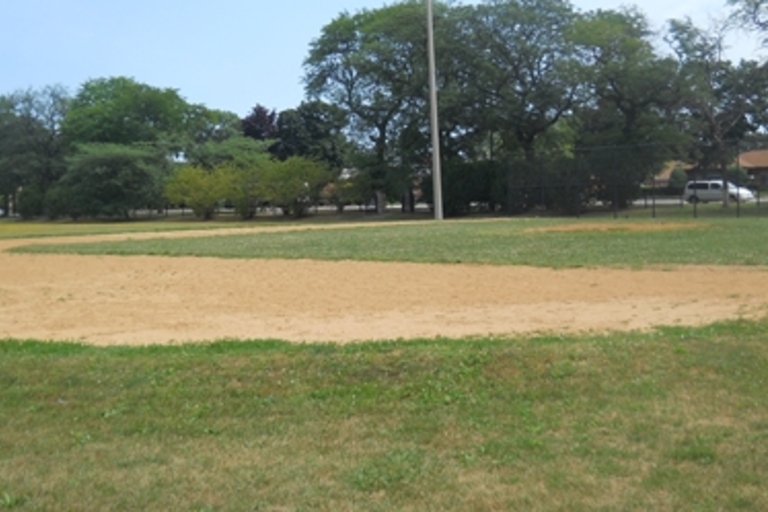 Empty baseball field infield on a sunny day.
