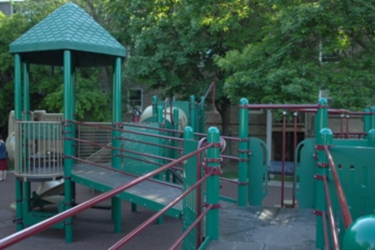 Accessible green playground with ramp.