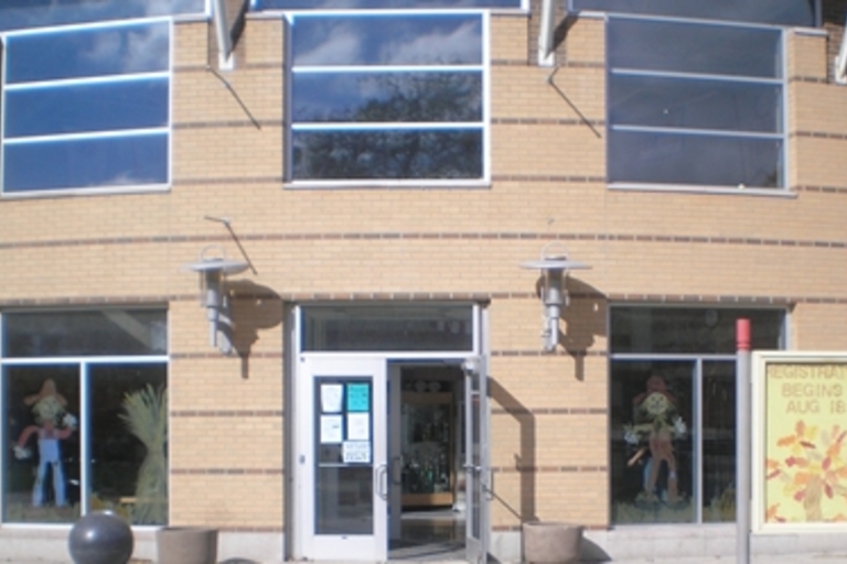 Community center entrance with scarecrow decorations.