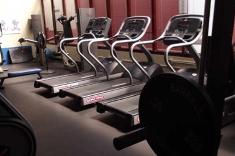 Treadmills and other exercise equipment in a fitness center.
