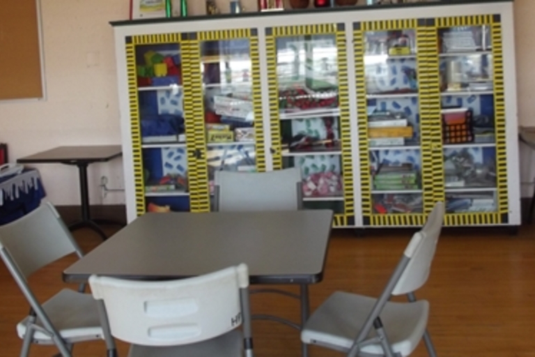 Classroom with games, tables, and chairs.