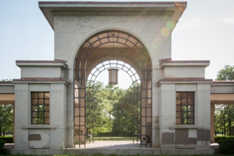 Large stone archway in a park.