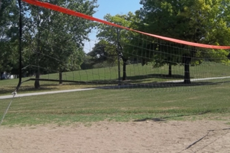 Outdoor volleyball net on a sand court.