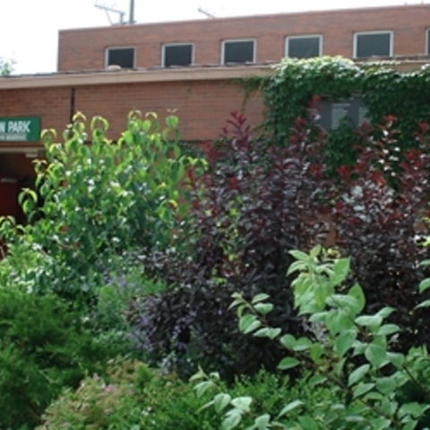 Anderson Park field house with lush greenery.