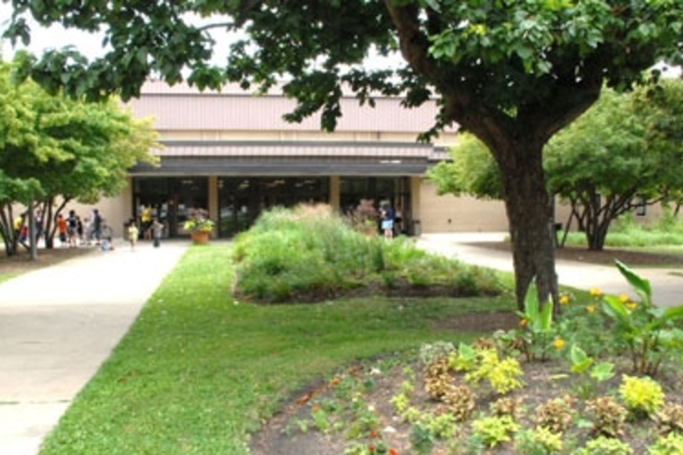 Community center entrance with landscaped gardens and walkways.