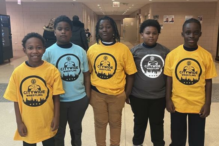 Five young wrestlers wearing Citywide Wrestling t-shirts.