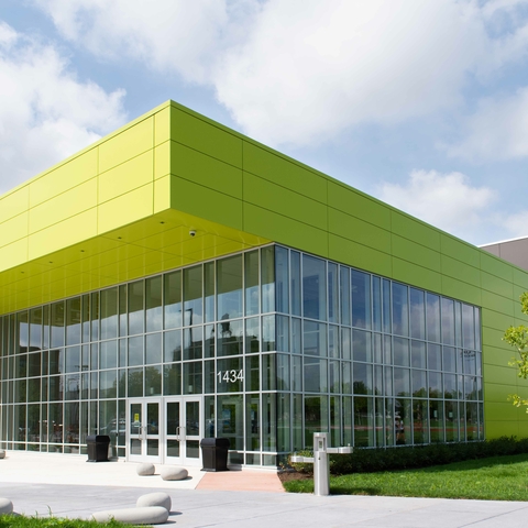 Modern building with lime green panels and large glass windows.