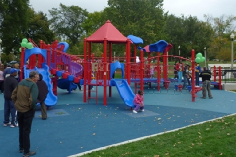 Kids play on a red and blue playground.