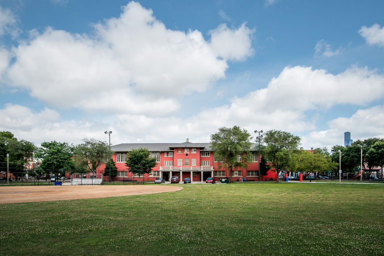 Red brick building at a park with baseball diamond.