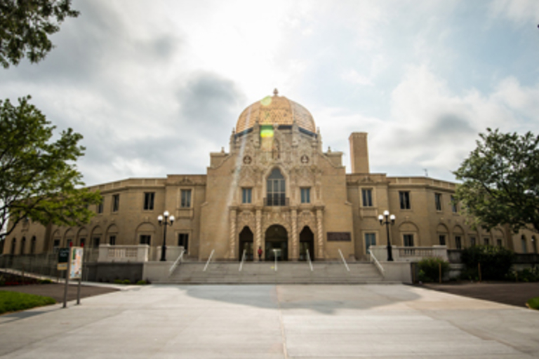 The Asbury Park Convention Hall, a grand building with a gold dome and ornate facade.