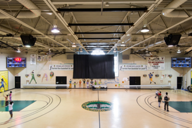 Children playing in a brightly lit gymnasium.