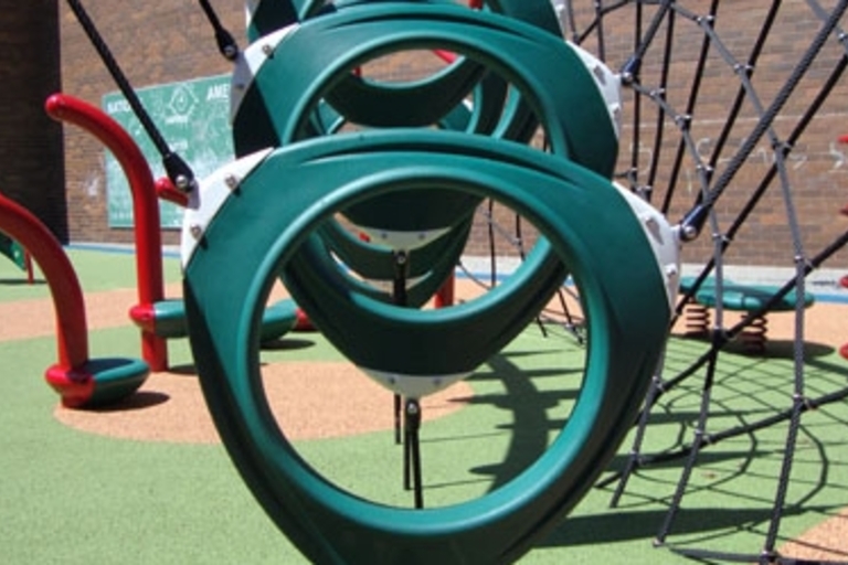 Green hanging rings on a playground.