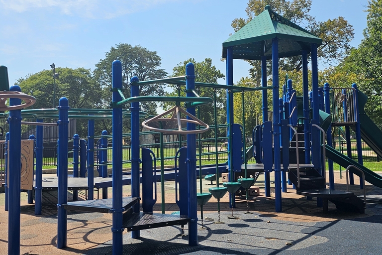 Blue and green playground structure with slide and climbing features.