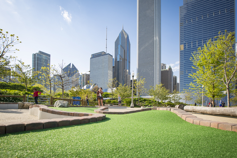 People enjoy a mini golf course with Chicago skyscrapers in the background.