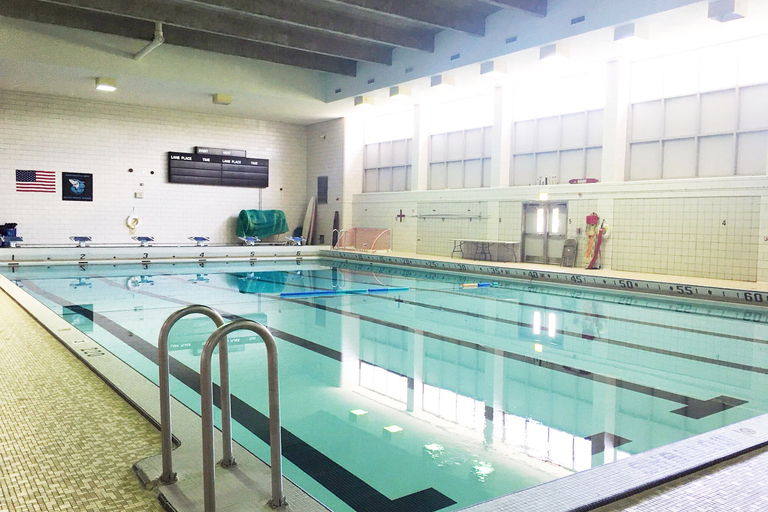 Indoor swimming pool with lane markers and starting blocks.