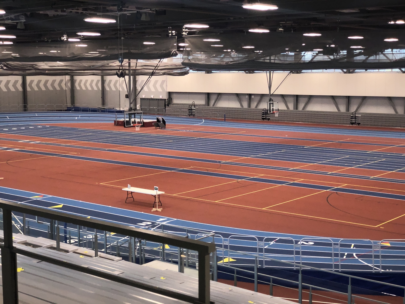 Indoor track and field facility with a red and blue track.