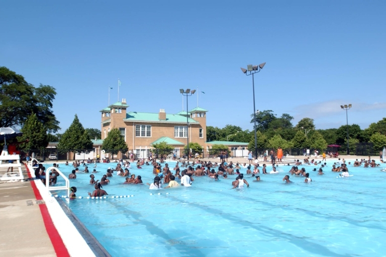 Crowded public pool on a sunny day.