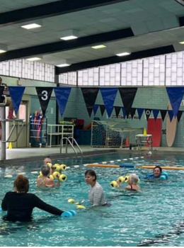 Group participates in water aerobics class.