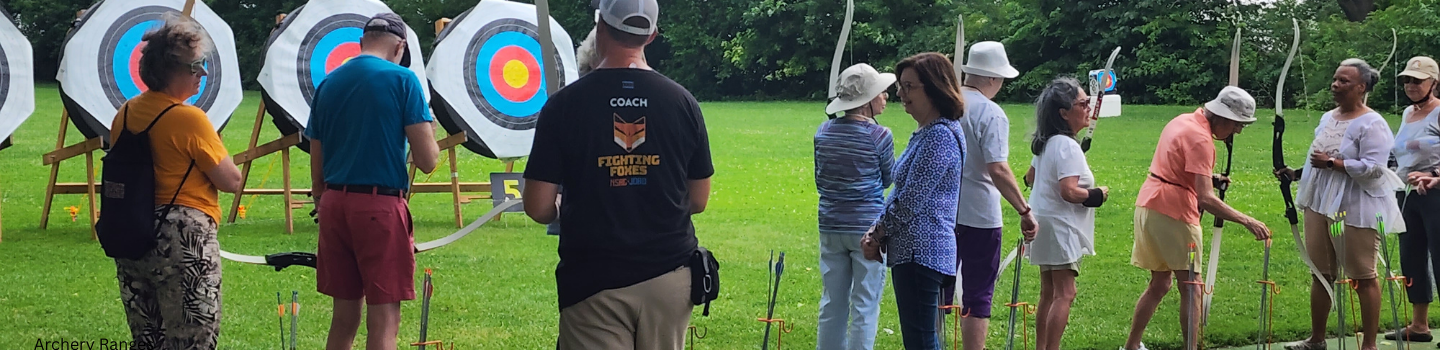 Archers practice at an outdoor archery range.