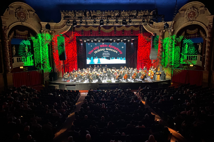 Symphony performing a holiday concert with full house.