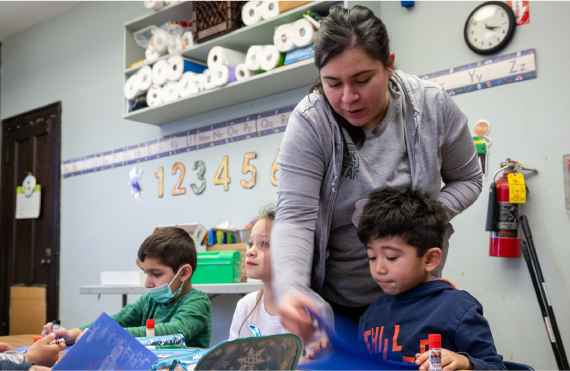 Woman assisting children